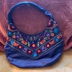 Single strap embroidered leather handbag.